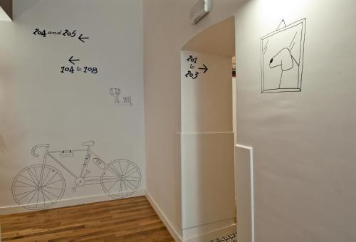 a room with a bike stenciled on the wall at Hotel Piazza Bellini & Apartments in Naples
