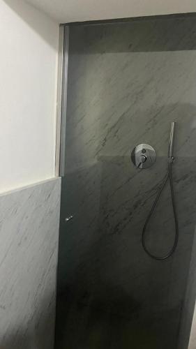 a shower with a shower head in a bathroom at Stupendo bilocale nuovissimo con finiture di lusso in Carrara
