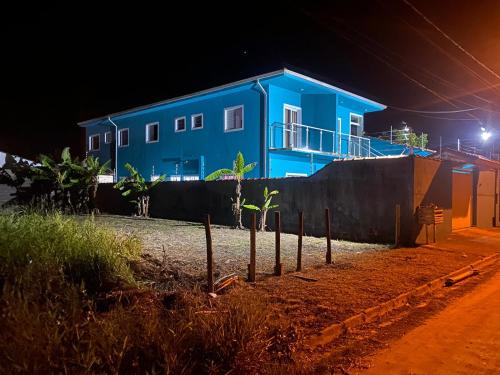 a blue house on a street at night at Pousada Viva a Vida in Ilha Comprida