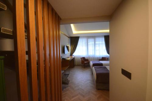 a hotel room with a bed and a desk at Snowflake Dag Hotel & SPA in Sarıkamıs