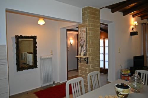 a dining room with a table and a mirror at Dimos Suite in Arachova