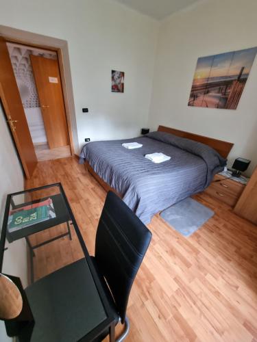 a bedroom with a bed and a table and a desk at Alloggio Silva in Gorizia