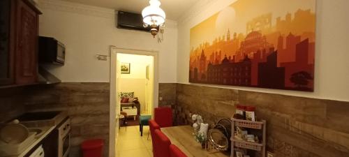 a living room with a table and a painting on the wall at Authentic Belgrade Centre Hostel - Only private rooms in Belgrade