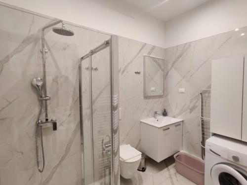 a bathroom with a shower and a toilet and a sink at APARTMENT Dominik **** in Zagreb