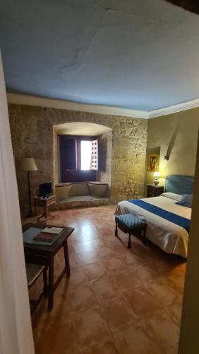 a large bedroom with a bed and a window at Casa Palacio Conde de Garcinarro in Huete