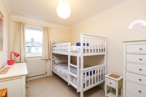 a bedroom with two bunk beds and a desk at Hope House in East Cowes