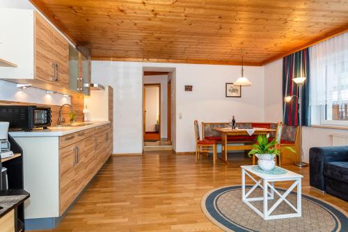 a kitchen and living room with a couch and a table at Pension Hauser in Sankt Jakob in Haus