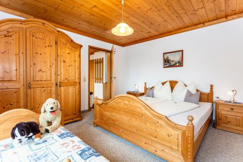 a bedroom with two beds and a teddy bear sitting on a bed at Pension Hauser in Sankt Jakob in Haus