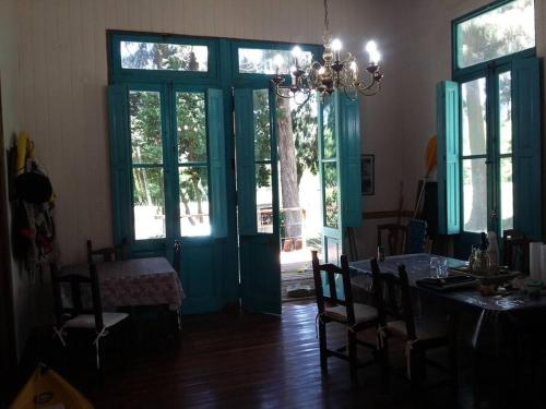 a dining room with a table and a blue door at Casa SUPIAVENTO RIO Delta Tigre 8 PREMIUM WIFI in Dique Luján