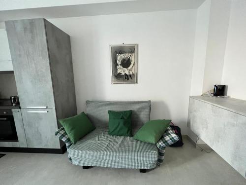 sala de estar con sofá y 2 almohadas verdes en B&B 208, en Troia