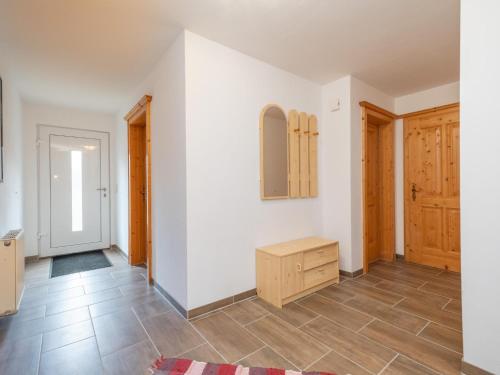 a living room with white walls and wooden floors at Haus Durchegg OG in Wagrain