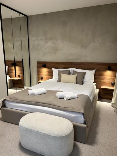 a bedroom with a large bed and a large mirror at Pałac Widokowy in Toruń