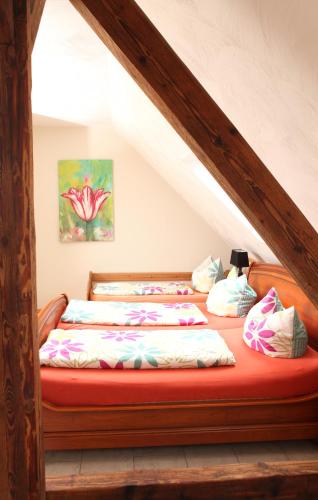 a bedroom with a bed with a red mattress at Heidehof Pension B & B in Elten