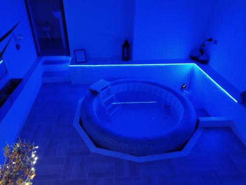 a blue bathroom with a tub in a room at First house in Brindisi
