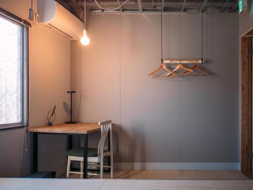a room with a table and a chair next to a wall at Center - Vacation STAY 18175v in Kanuma