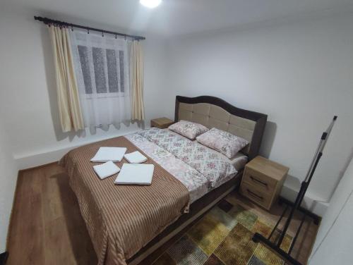 a bedroom with a bed with two boxes on it at Apartman Jakša in Žabljak