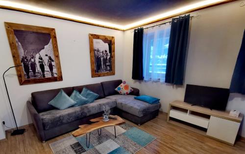 a living room with a couch and a table at Haus Dirol in Kirchberg in Tirol