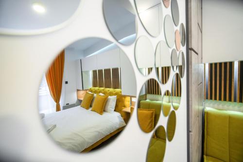a bedroom with a bed and a mirror at Pleasure Lux MILMARI-Kopaonik in Kopaonik