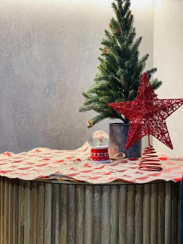 a table with a christmas tree and two stars at Hotel Pass, Laureles Medellín in Medellín