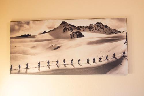 a picture of a group of people walking across a desert at Hotel Garni Alpenhof in Ischgl