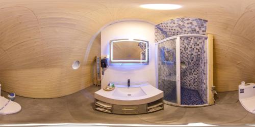 a circular bathroom with a sink and a shower at NIVADOO RESORT SIGIRIYA in Sigiriya