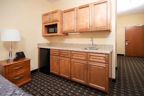 a kitchen with wooden cabinets and a sink at Mt. Rose Hotel in Fayetteville