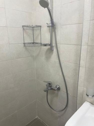 a shower with a shower head in a bathroom at Hillside Bakuriani in Bakuriani
