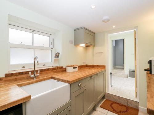 a kitchen with a sink and a window at Granary Cottage in Warminster