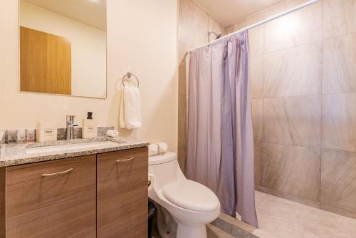 a bathroom with a toilet and a shower at Roma Norte Apartments by VH in Mexico City