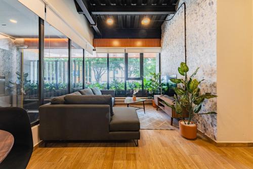 a living room with a couch and a table at Roma Norte Apartments by VH in Mexico City