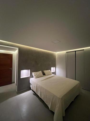 - une chambre avec un grand lit et deux lampes dans l'établissement Casa da Lua, à São Miguel do Gostoso