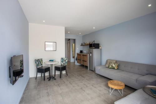 a living room with a couch and a table at INDIGO Apartments & Suites - 'Adults Only' in Jan Thiel