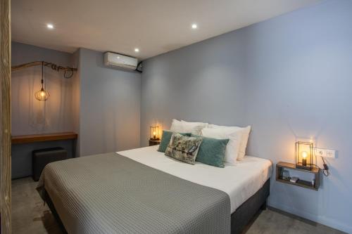 a bedroom with a large bed with two lamps at INDIGO Apartments & Suites - 'Adults Only' in Jan Thiel