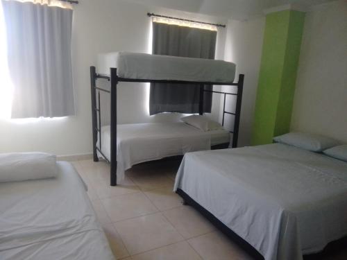 a room with two bunk beds in a room at HOTEL BOSQUE DE LAS AMERICAS in Cartagena de Indias