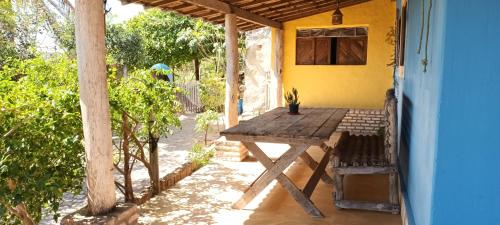 a wooden table sitting outside of a house at Casinhas Vila Bonita Marajás in Baía Formosa