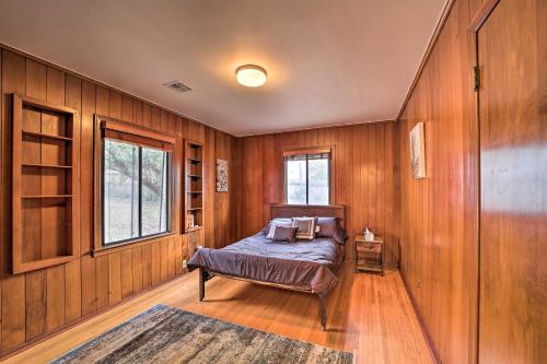a bedroom with wooden walls and a bed in a room at Tulsa Rental Home - Walk to Philbrook Museum in Tulsa