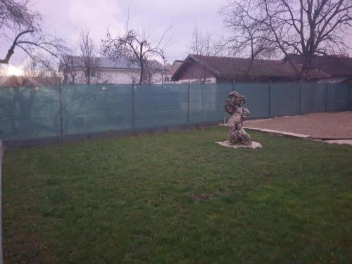 a statue in the grass in a yard at Vila Dionysos Brasov in Braşov