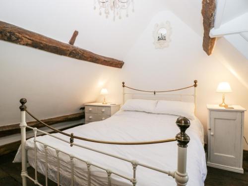 a bedroom with a bed and two night stands at Foxden in Sherborne