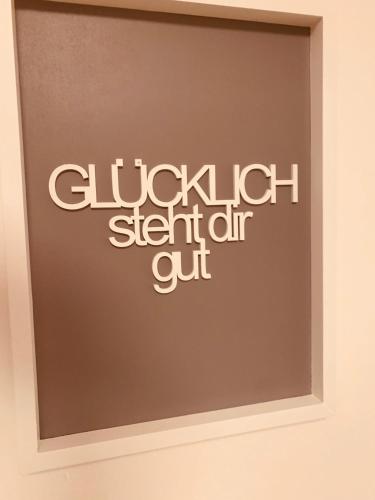 a sign on a wall with the clkich stair air cut at FELIX LIVING 3, modern & cozy 2 Zimmer Wohnung, Netflix, Parkplatz in Salzweg