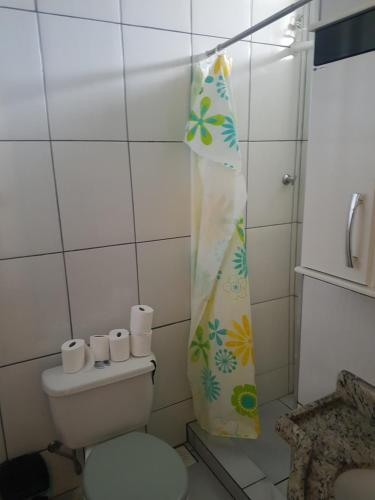 a bathroom with a toilet and a shower curtain at Kitnet mobiliado centro in Nova Friburgo
