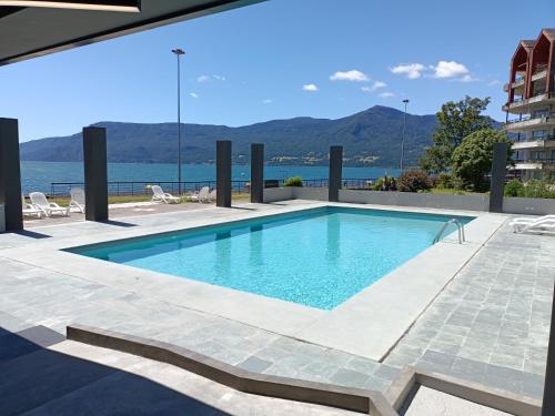 a swimming pool with a view of the water at Hotel Enjoy Pucon in Pucón