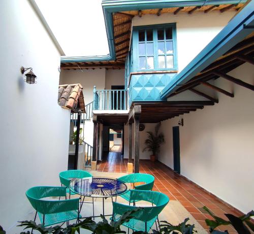 a patio with a table and chairs on a building at Trip Monkey Girón in Girón