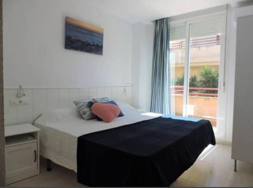 a bedroom with a large bed with a window at Apartment with terrace and pool by the sea in Los Caños de Meca