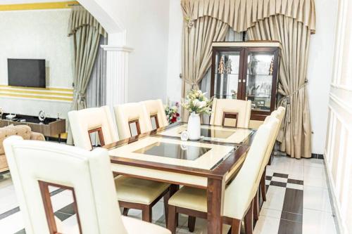 a dining room with a table and chairs at Beautiful home with private rooms in Pantang