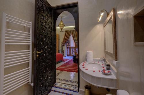 a bathroom with a sink and a mirror at Riad Diamond Of Marrakech in Marrakech