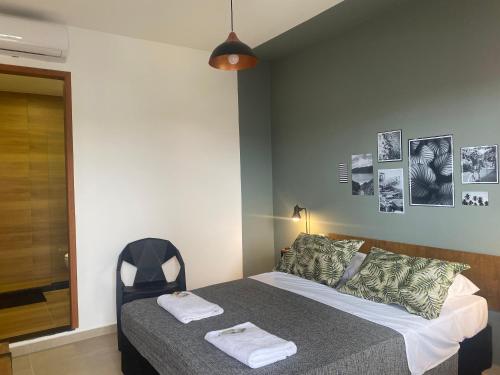 a bedroom with a bed with two towels on it at A Coroa Hostel & Pousada in Arraial do Cabo