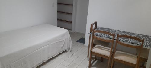 a bedroom with a bed and a chair in it at LA CASITA in Buenos Aires