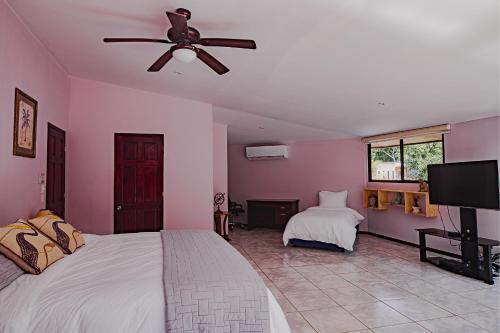 a bedroom with a bed and a ceiling fan at Casa Melosa in Potrero