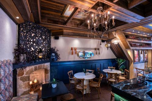 a dining room with tables and a fireplace at DECAN Concept Boutique Estate in Rhodes Town