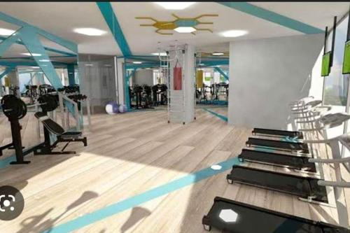 a gym with several treadmills and machines in a room at Superb residence,pool,gym,sauna in Istanbul